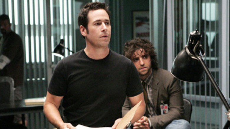 Don Eppes (Rob Morrow) and Charlie Eppes (David Krumholtz) stare intently in an office in Numbers