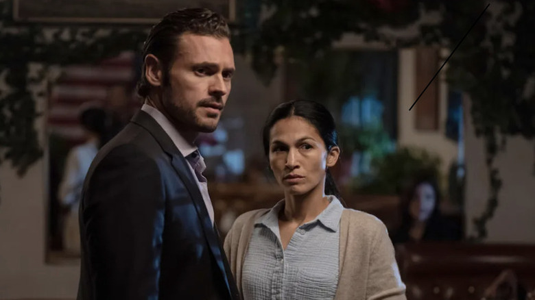 Arman Morales (Adan Canto) stands next to Thony De La Rosa (Élodie Yung) in The Cleaning Lady (2022)