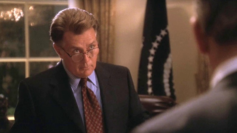 Josiah Barlett (Martin Sheen) peering over glasses at staffer in The West Wing