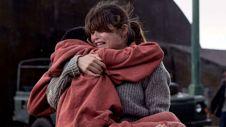 woman running with a child in her arms