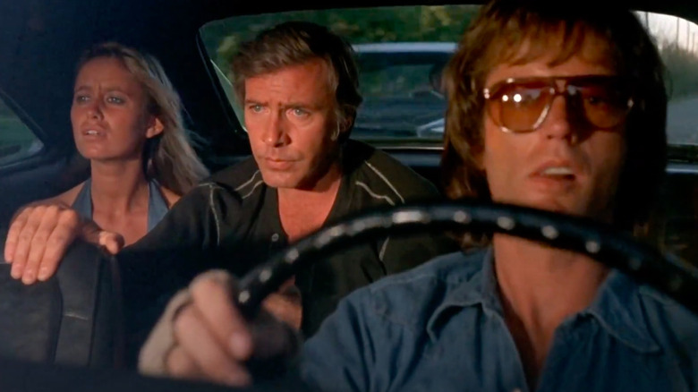 Larry, Deke, and Mary driving in a car