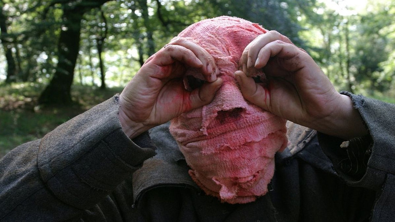 Man in pink bandage mask
