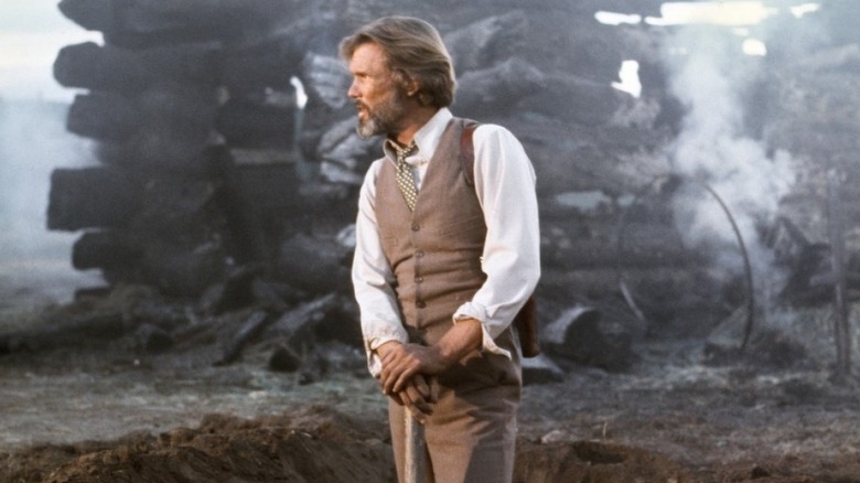James Averill (Kris Kristofferson) stands by a burned out log cabin in Heaven's Gate