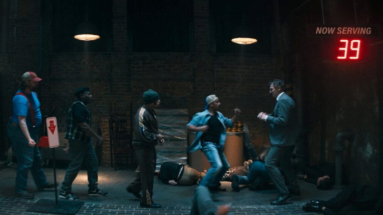 Frank Drebin Jr. (Liam Neeson) fighting a line of bad guys one-by-one in The Naked Gun (2025)
