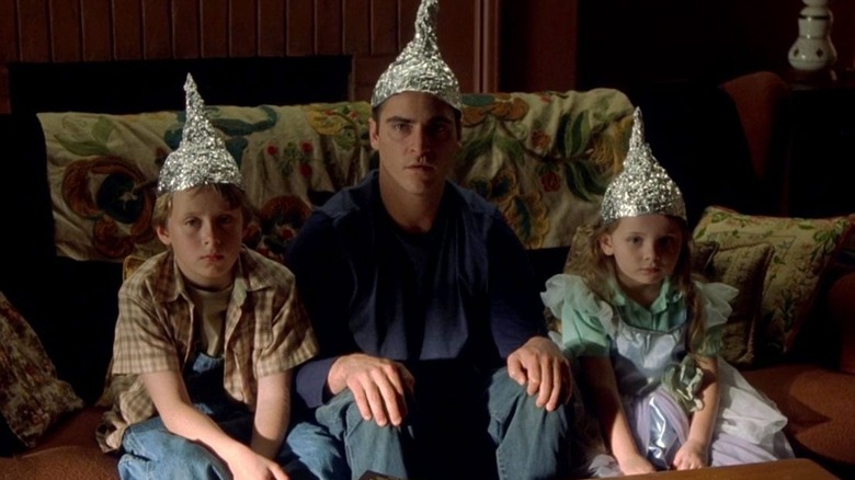 Joaquin Phoenix with kids in tin foil hats