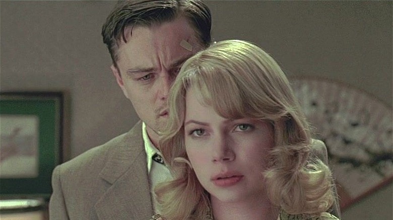 Michelle Williams standing in front of Leonardo DiCaprio in Shutter Island