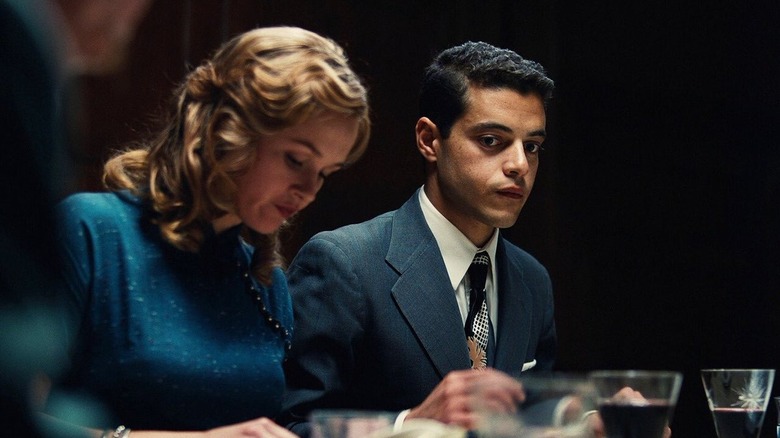 Rami Malek sitting at dinner table