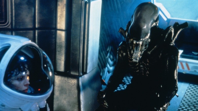 Xenomorph approaches Ripley in her spacesuit