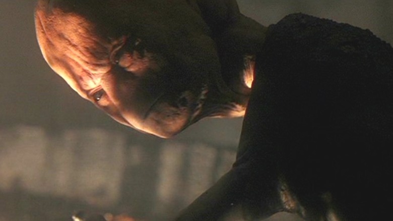 Alien stands over abductee