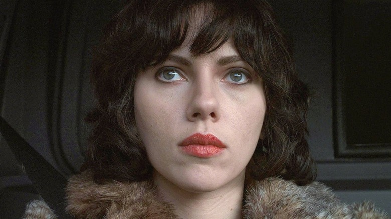 The Female wears a fur coat and drives a truck