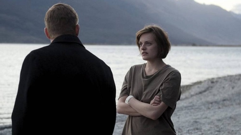 Elizabeth Moss listens on a beach