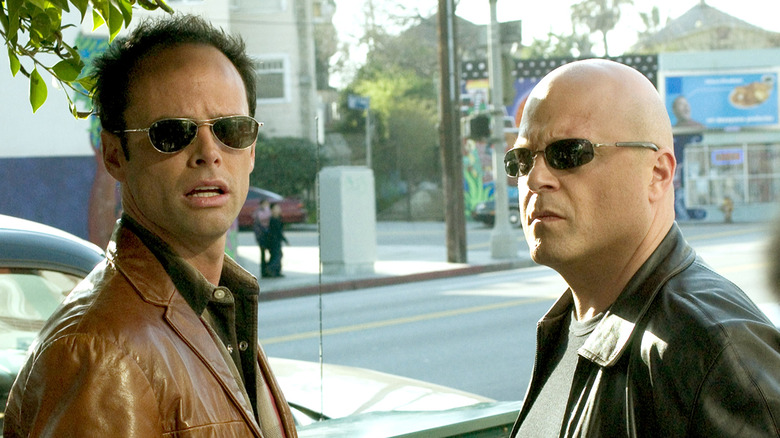 Walton Goggins and Michael Chiklis conferring 