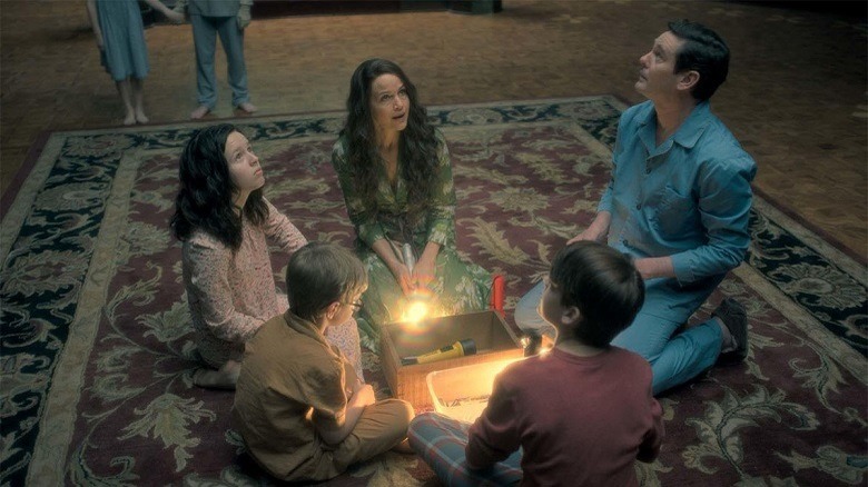 The Crain family kneeling on their rug