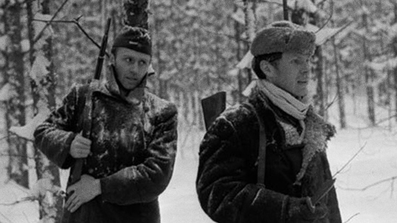 Two men walk in the snow