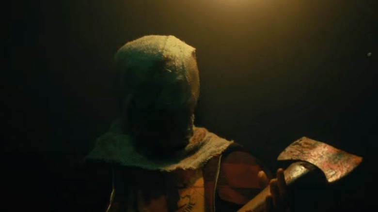 Hooded figure with an ax