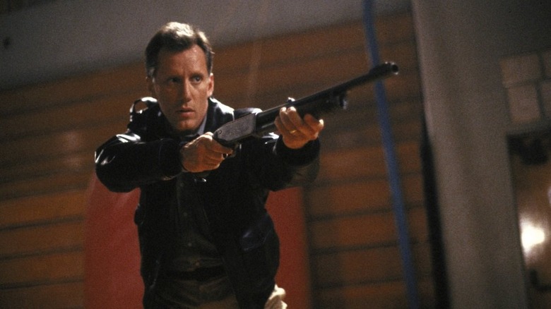 James Wood leading with a shotgun