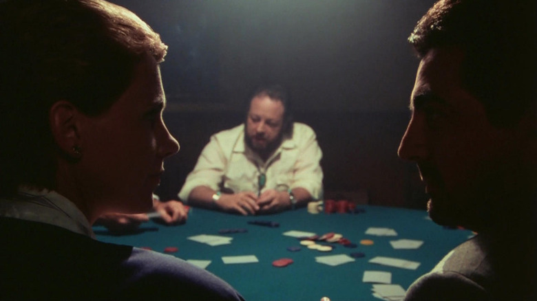 Joe Mantegna instructing Lindsay Crouse across a card table from Ricky Jay