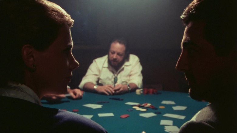 Joe Mantegna instructing Lindsay Crouse across a card table from Ricky Jay