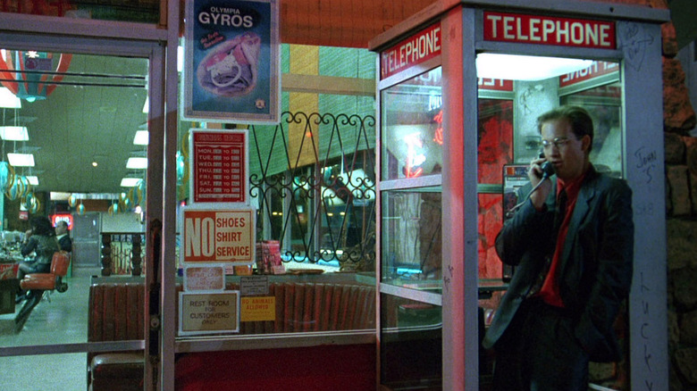 Anthony Edwards using a phonebooth