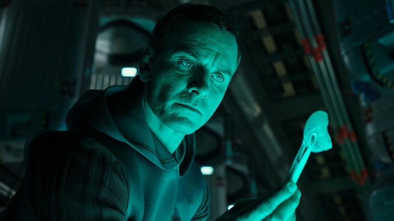 Walter (Michael Fassbender) holds up an embryo in Alien: Covenant