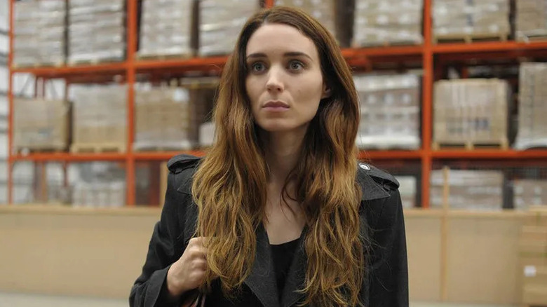 Una Spencer (Rooney Mara) stands by lumber in a hardware store in Una