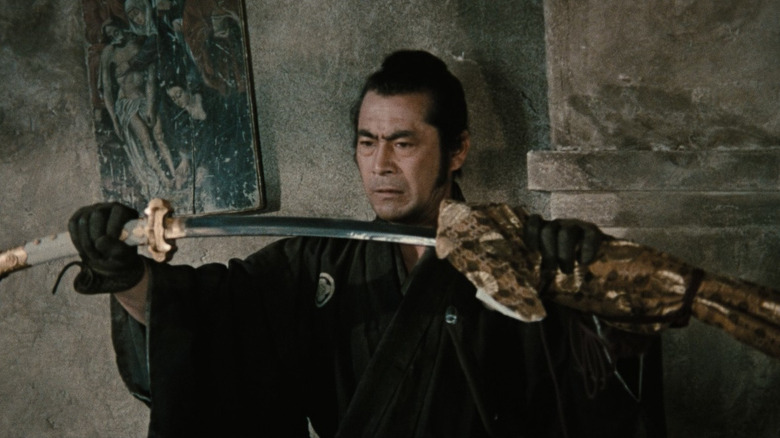 Jūbei Kuroda (Toshiro Mifune) draws a samurai sword in Red Sun