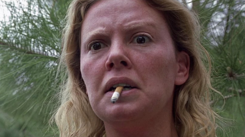 Charlize Theron as Aileen Wuornos smoking in Monster