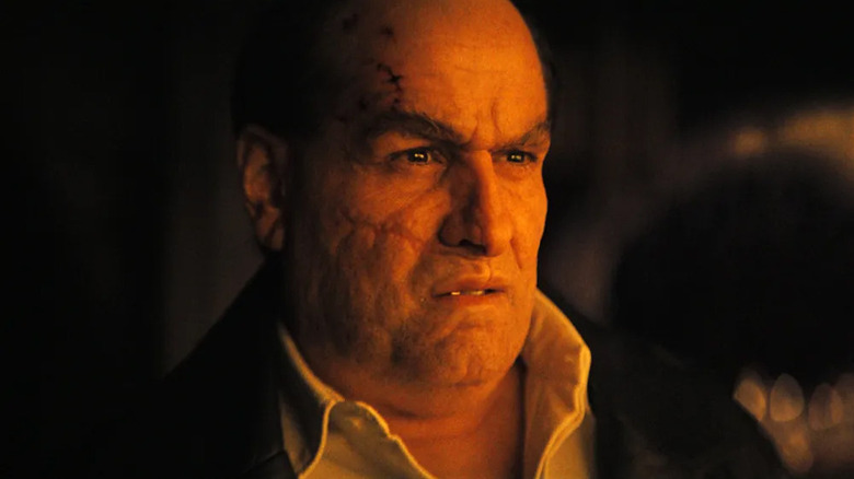 Colin Farrell as Penguin/Oz Cobb stares at the flooded city in The Batman