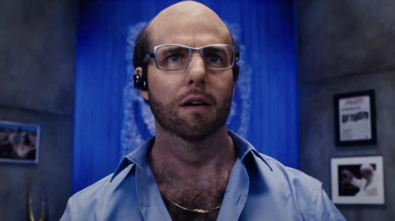 Tom Cruise as Les Grossman talking on his headset in Tropic Thunder