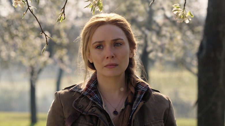 Elizabeth Olsen as Wanda Maximoff standing in a park in Doctor Strange in the Multiverse of Madness