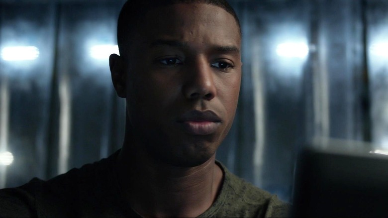 Michael B. Jordan as Johnny Storm looking at the screen in Fantastic Four