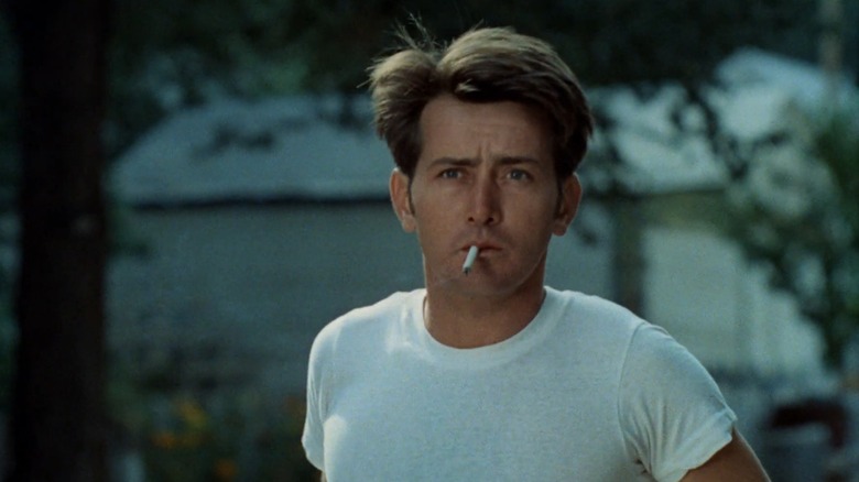 Kit (Martin Sheen) in a white t-shirt with a cigarette in his mouth, in Badlands