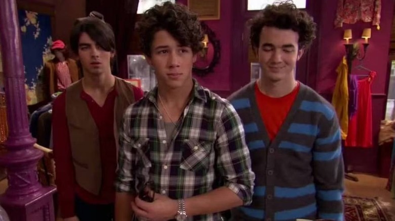 The Jonas Brothers in a dressing room on Jonas