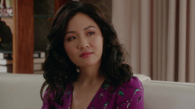Constance Wu as Jessica smiling and sitting in Fresh Off The Boat
