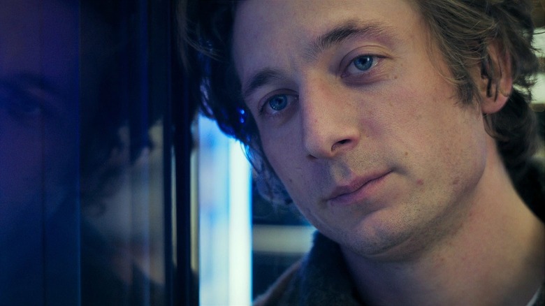 Jeremy Allen White as Carmy leaning his head against a fridge in The Bear