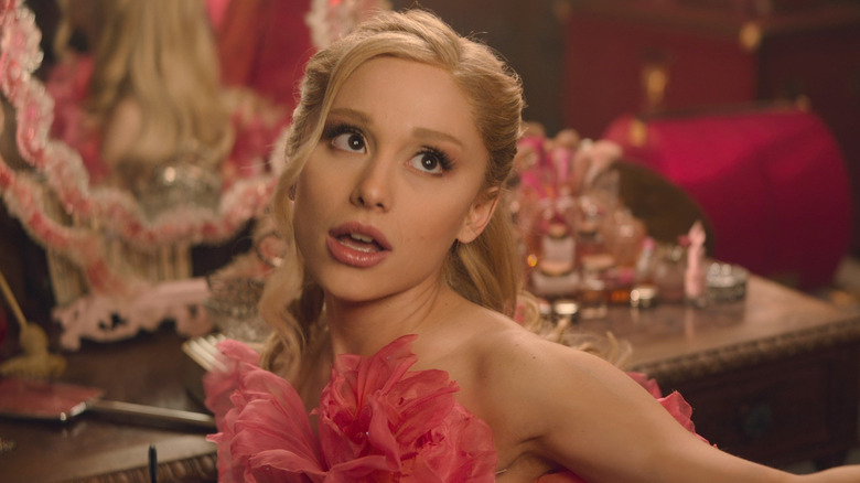 Ariana Grande as Galinda wearing a pink dress in Wicked