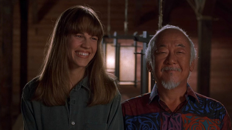 Hilary Swank as Julie Pierce smiling alongside Pat Morita as Mr. Miyagi in The Next Karate Kid