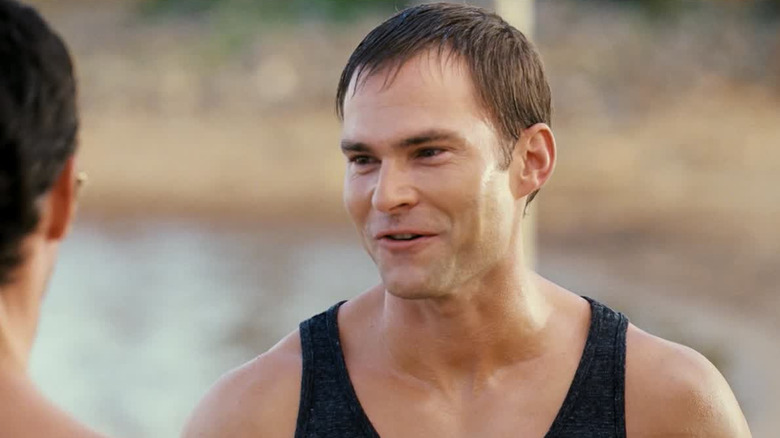 Seann William Scott smiling and talking while wet on a beach in American Reunion