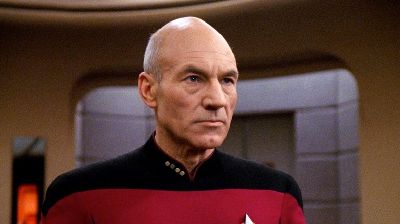 Patrick Stewart as Jean-Luc Picard stares intently while aboard spaceship in Star Trek: The Next Generation.