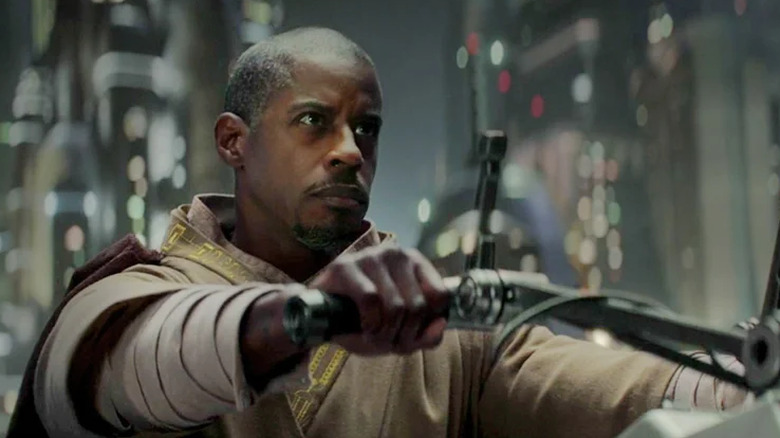Ahmed Best as Kelleran Beq, saving Grogu in The Mandalorian
