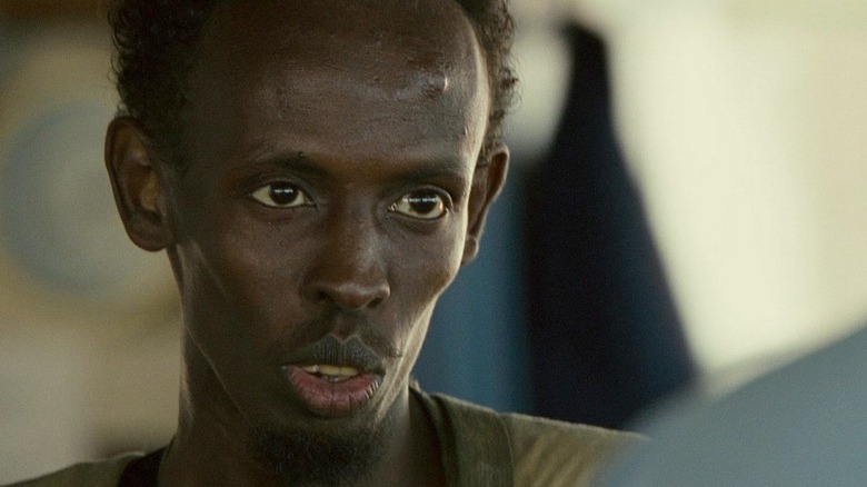 Barkhad Abdi as pirate Abduwali Muse, menacing Captain Phillips