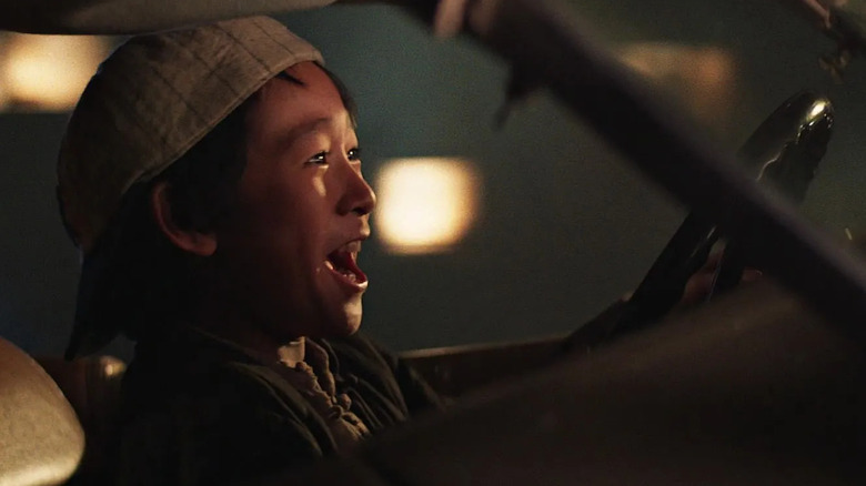 Ke Huy Quan as Short Round, driving the getaway car in Indiana Jones and the Temple of Doom