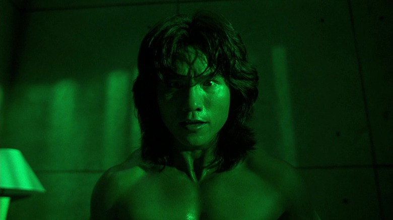 Robin Shou as Liu Kang awakens from a nightmare in Mortal Kombat