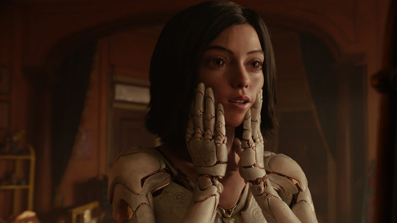 Rosa Salazar as Alita examines herself in the mirror in Alita: Battle Angel