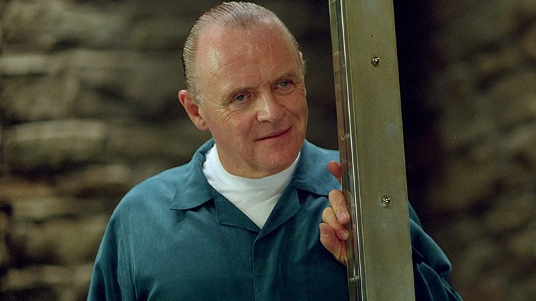 Anthony Hopkins as Hannibal Lecter, smiling in a cell in Red Dragon.
