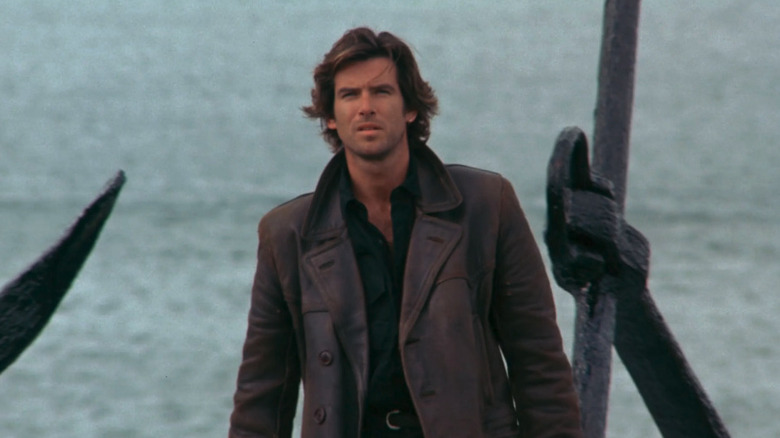 Pierce Brosnan as Mark Taffin, scowling near the ocean in Taffin.