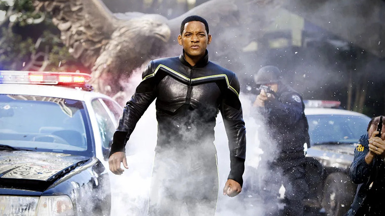 Will Smith as John Hancock, walking in front of police in Hancock.