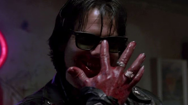 Bill Paxton's Severen pushes up his sunglasses with a bloody hand in Near Dark