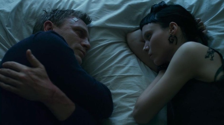Daniel Craig as Mikhail Blomkvist laying down next to Rooney Mara as Lisbeth Salander in The Girl With the Dragon Tattoo