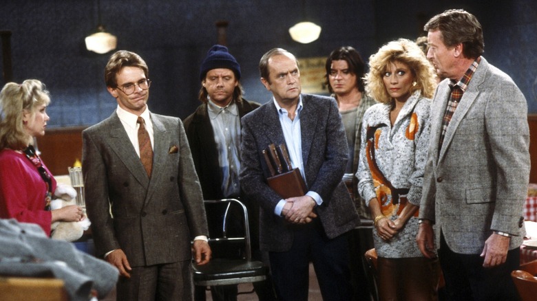 Julia Duffy, Mary Frann, Bob Newhart, Tony Papenfuss, Tom Poston, William Sanderson, and Peter Scolari as Stephanie Vanderkellen, Joanna Loudon, Dick Loudon, First Darryl, George Utley, Larry, and Michael Harris chat in a restaurant in Newhart